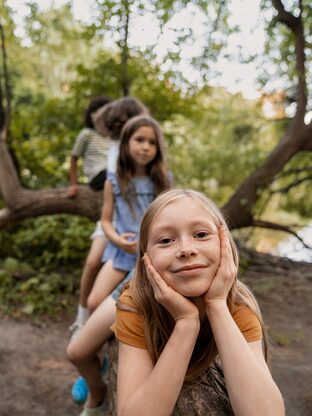 front-view-kids-sitting-log